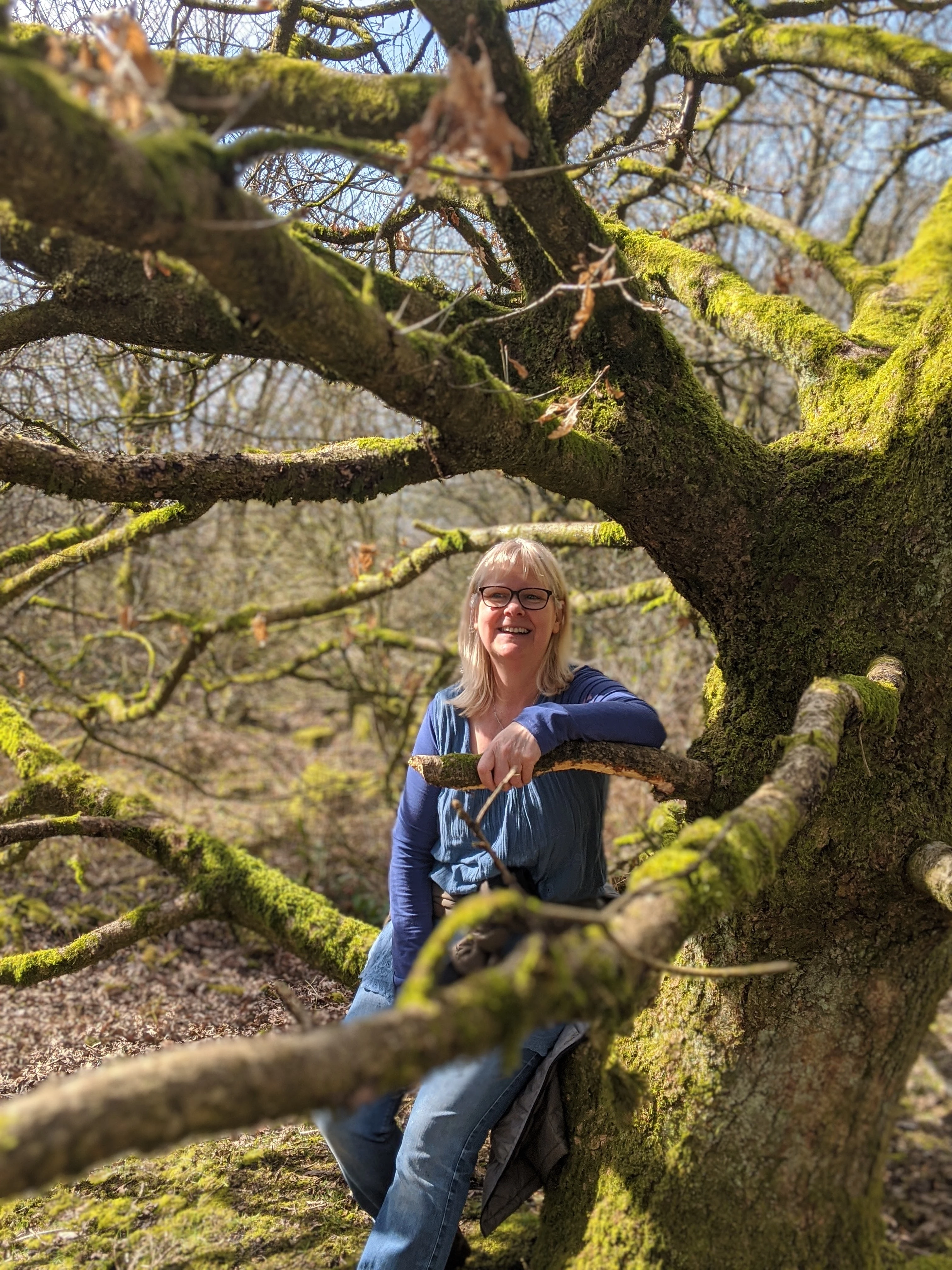 Vicky outdoors sat on a tree